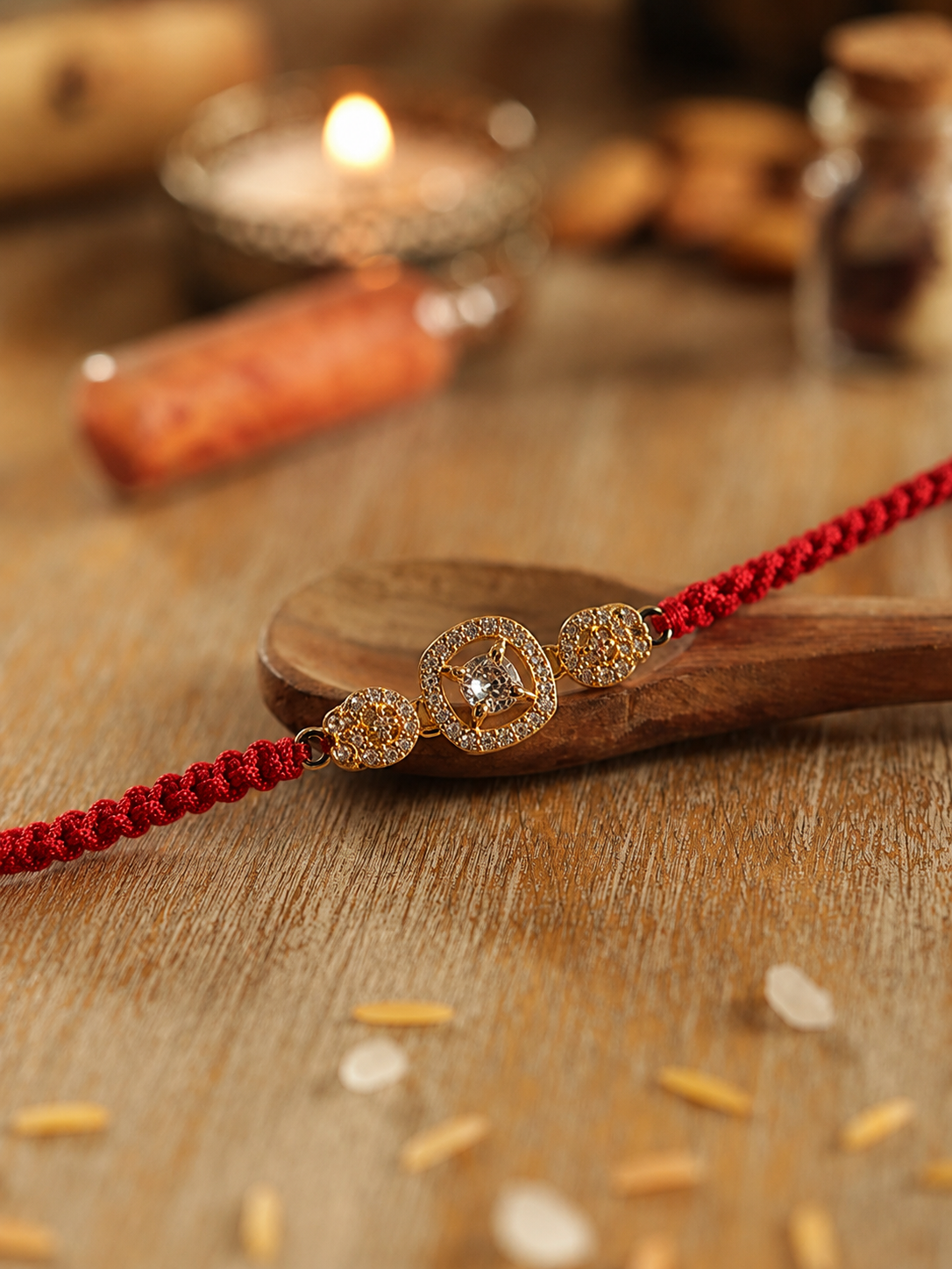 Gold three-stone sparkle motif rakhi detail