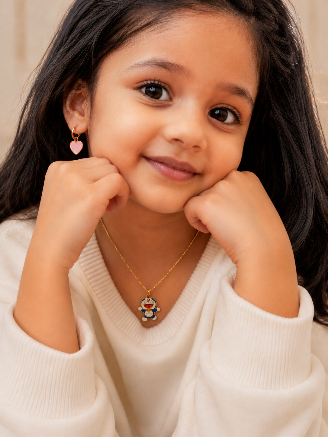 Smiling child wearing the gold-toned character pendant necklace