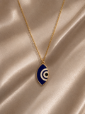 Cobalt and white marquise evil eye enamel pendant on a gold-toned chain on satin