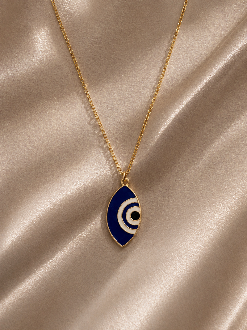 Cobalt and white marquise evil eye enamel pendant on a gold-toned chain on satin