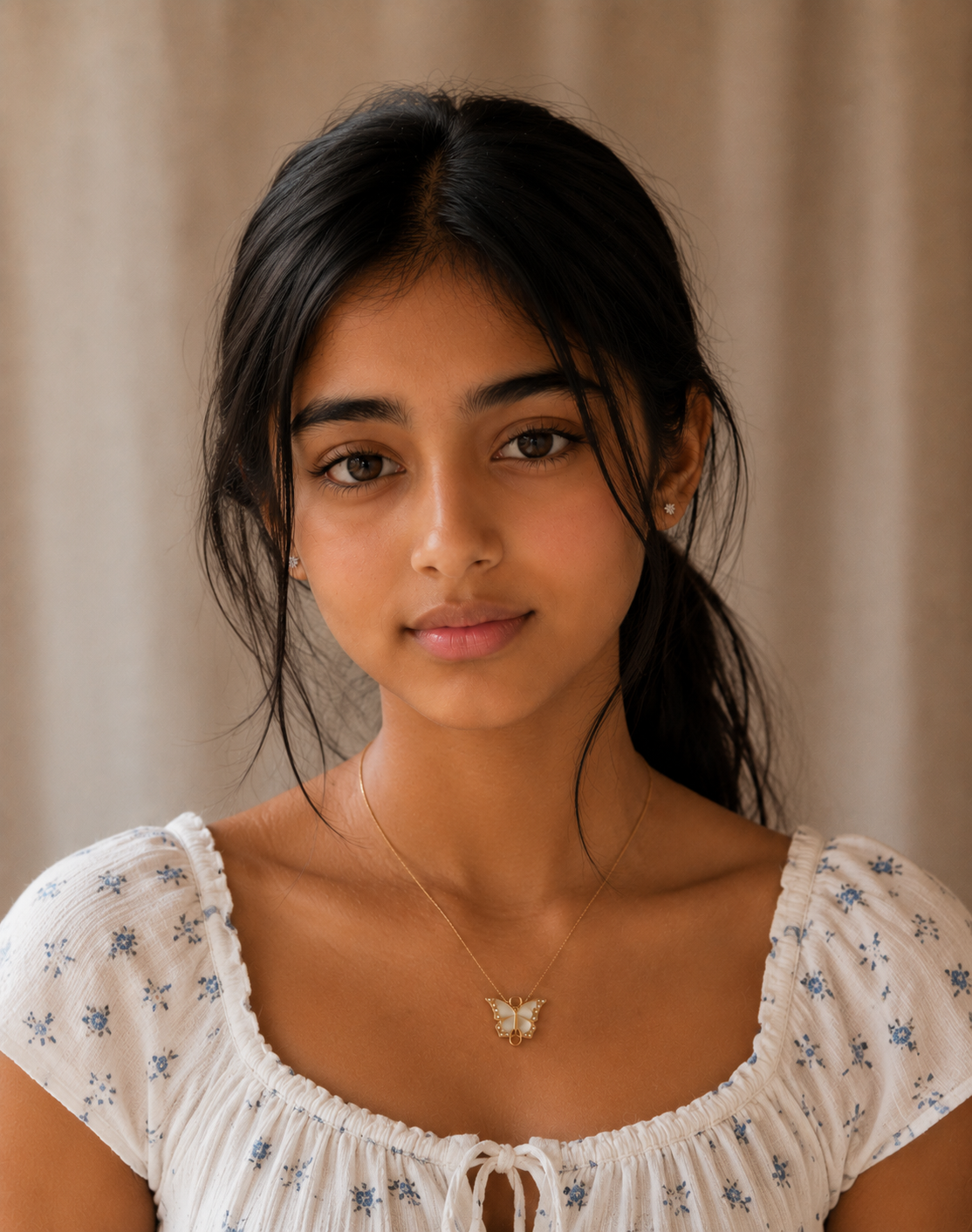 Close portrait of a woman wearing the dainty butterfly pendant necklace