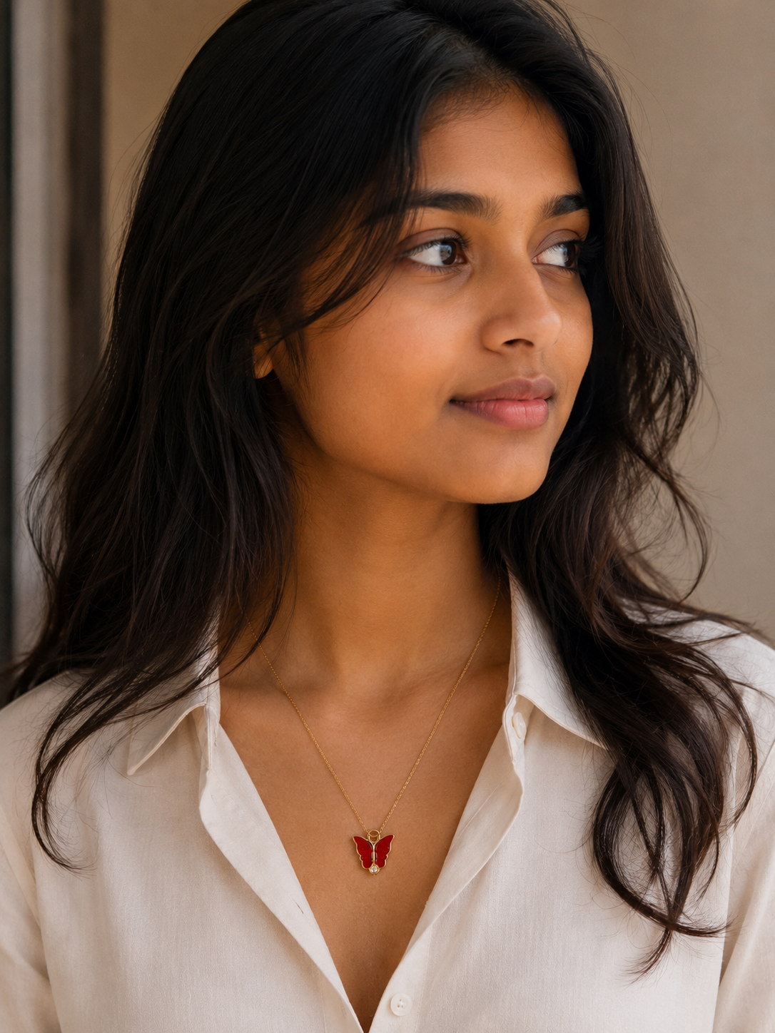 Portrait of a woman wearing the red butterfly pendant necklace