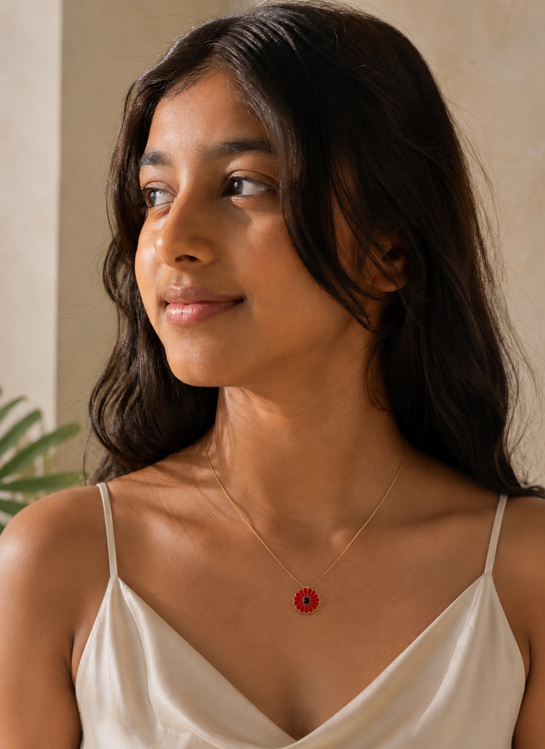 Portrait of a woman wearing the red flower pendant necklace