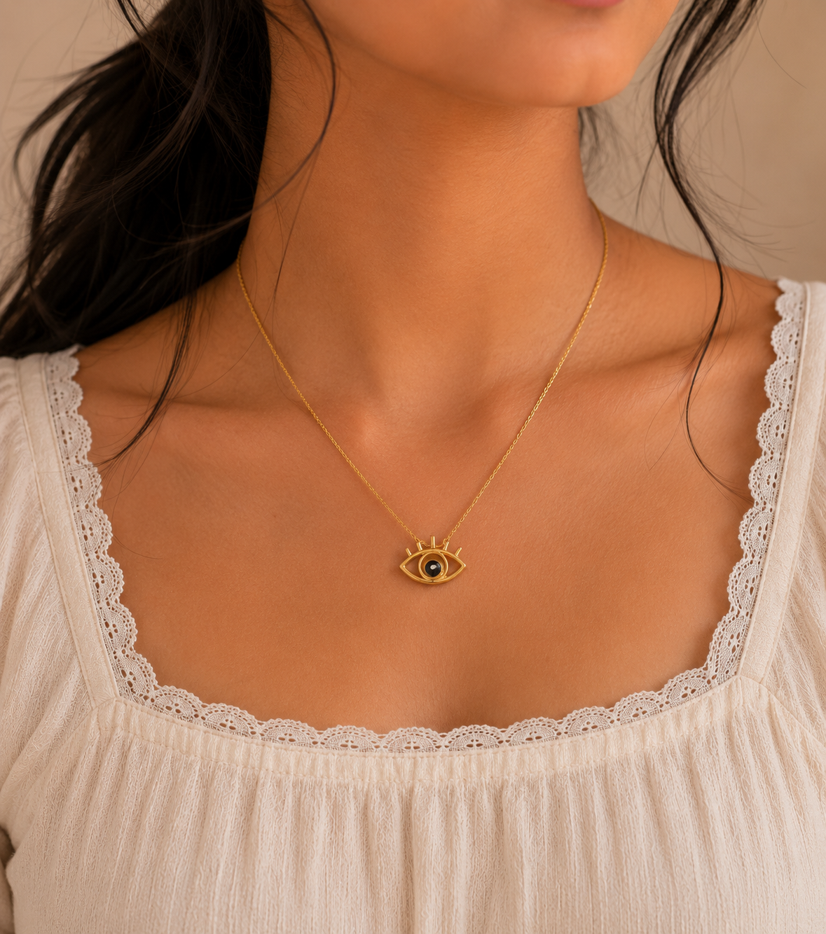 Woman wearing the evil eye pendant necklace with a white lace top