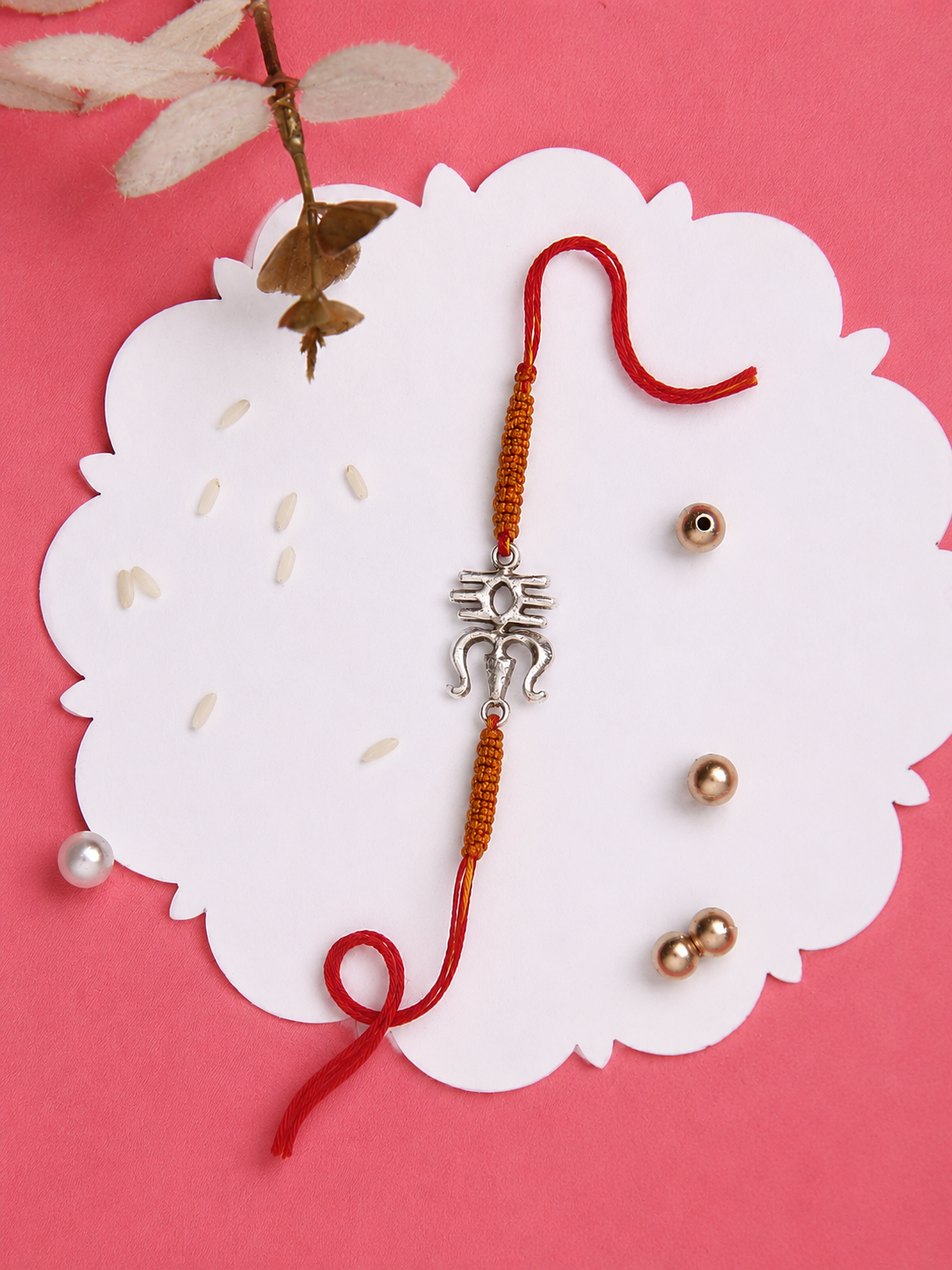 Silver Om calligraphy rakhi detail on saffron thread