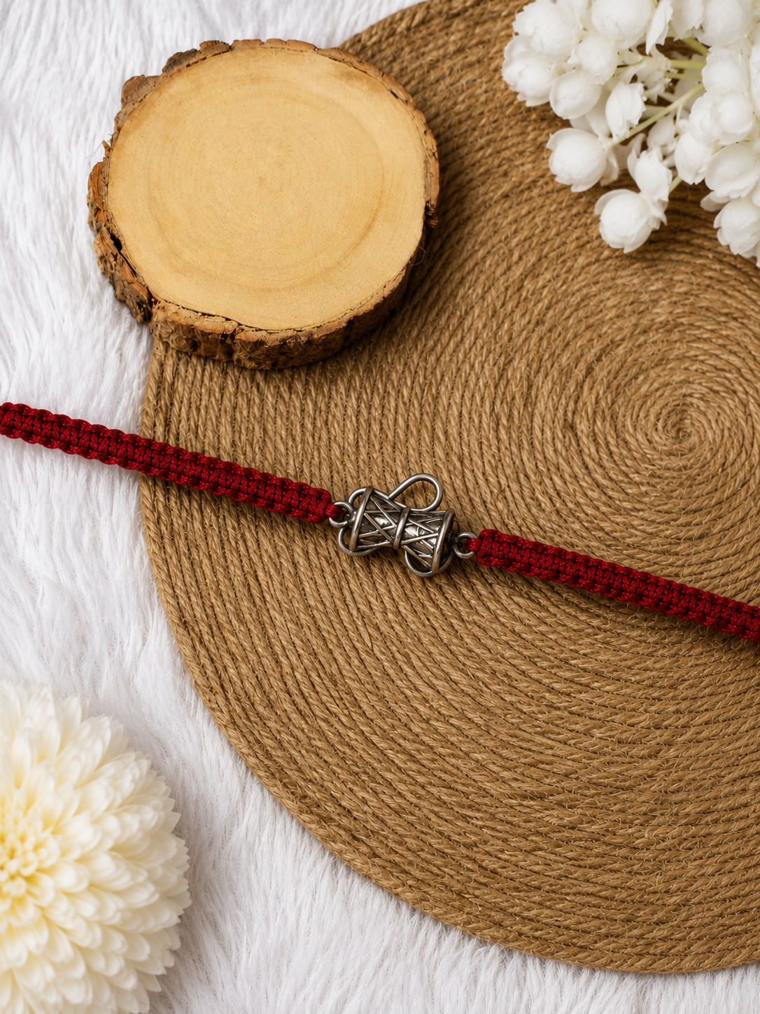 Silver bow motif rakhi detail on red thread