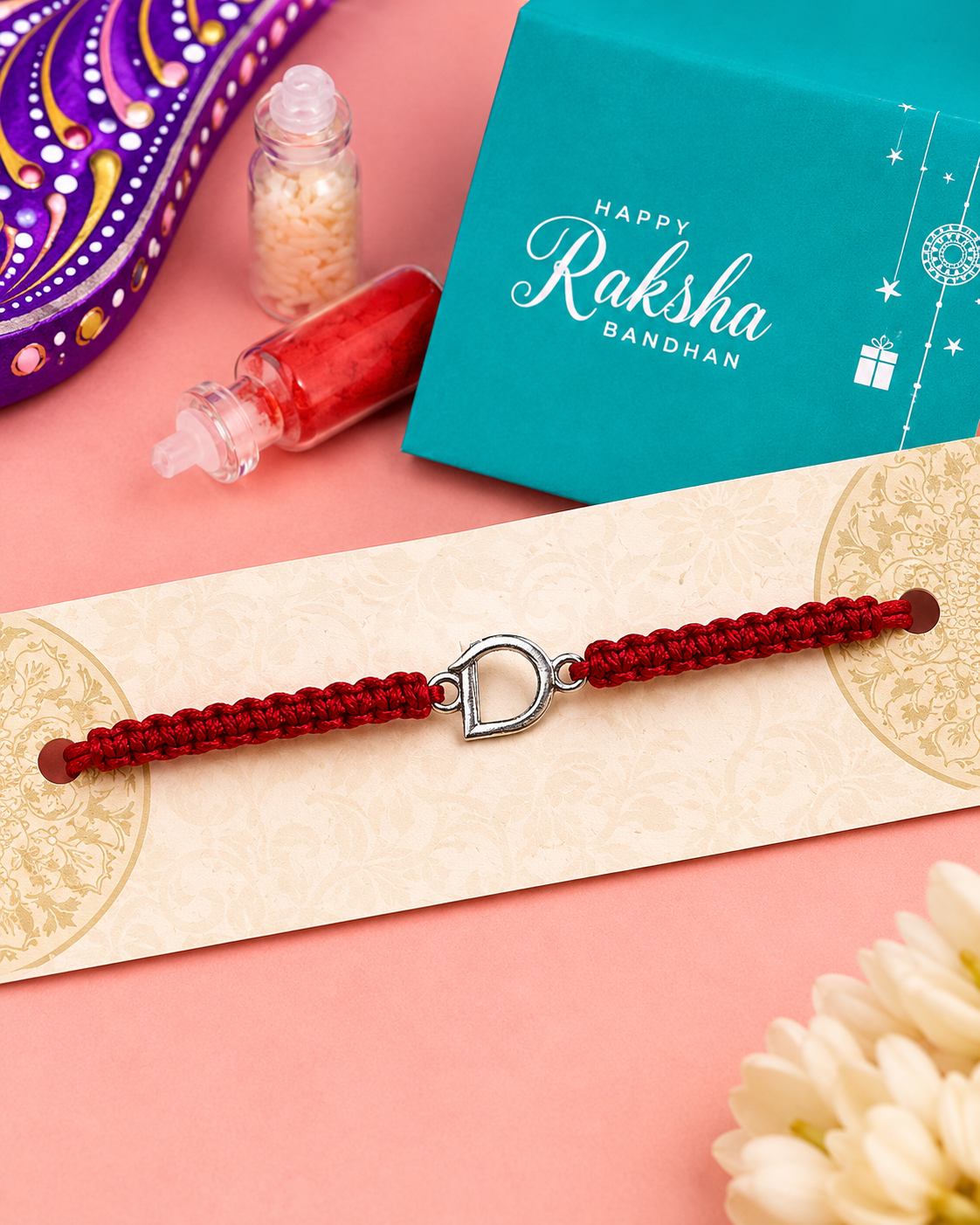 Silver initial D charm rakhi detail on red thread